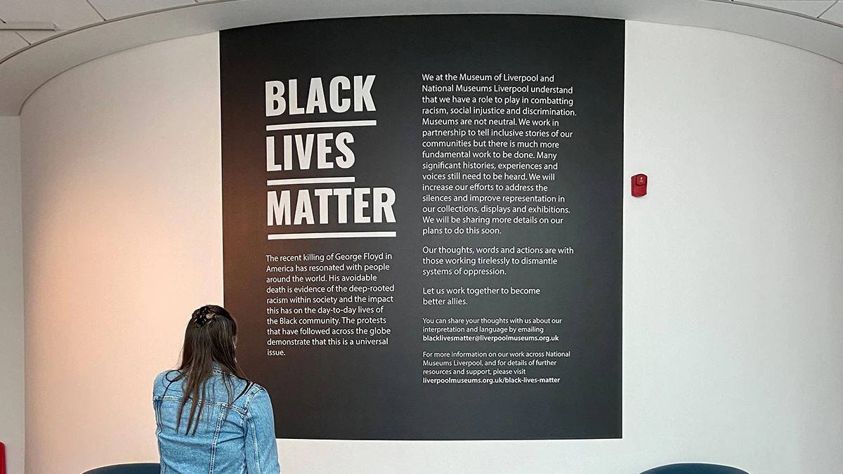 A person looking at Black Lives Matter messaging