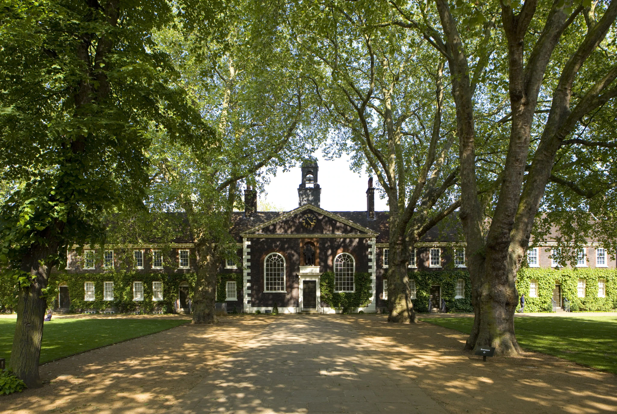An old building, the Museum of the Home, with trees in the foreground