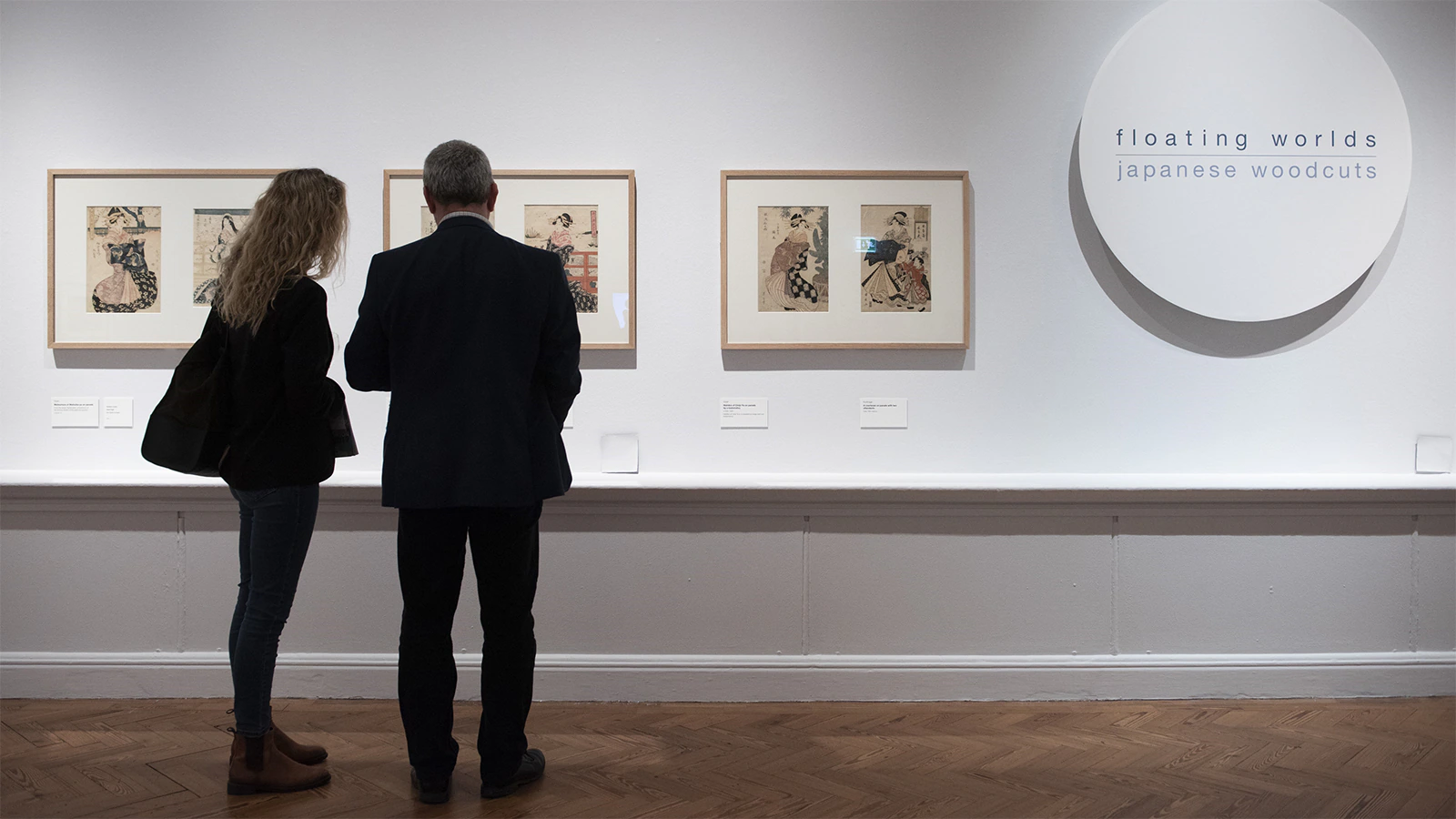 Two people look at an exhibit