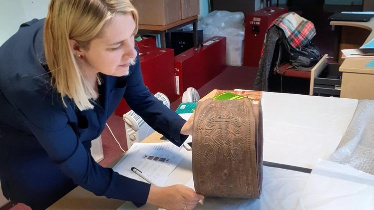 A person holds an artefact
