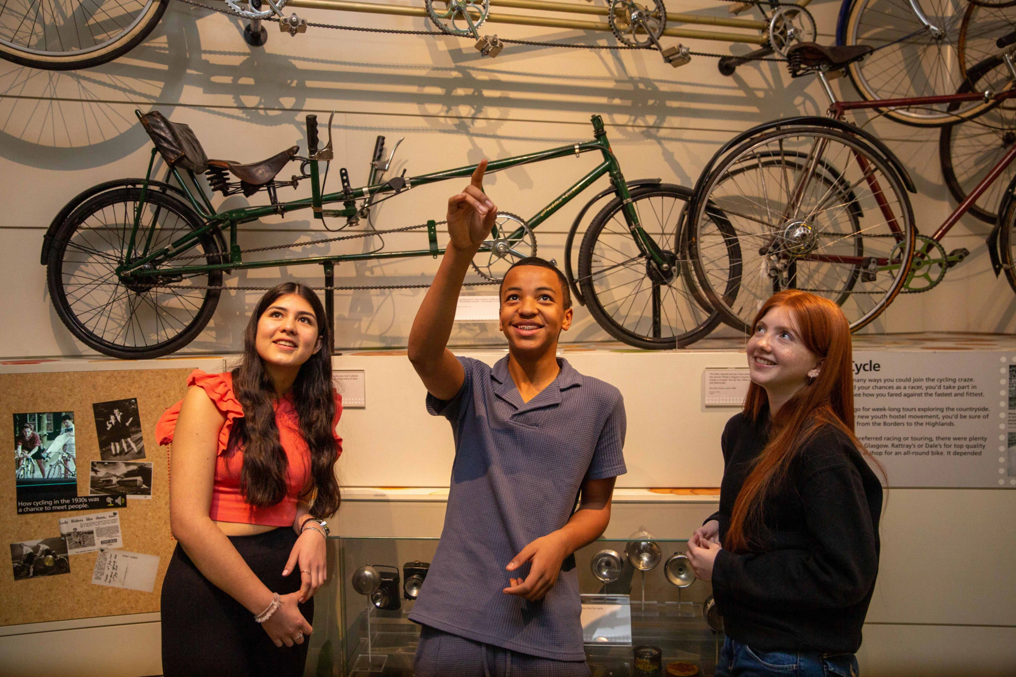 Teenage visitors in front of a display of bicycles