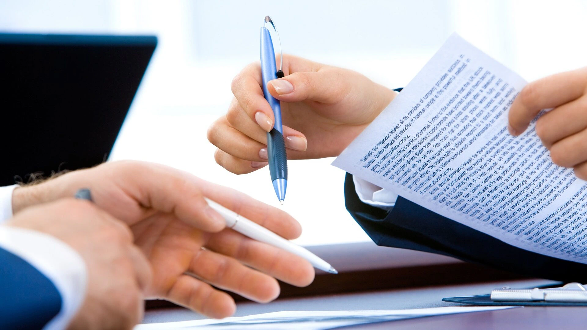 People holding documents and pens