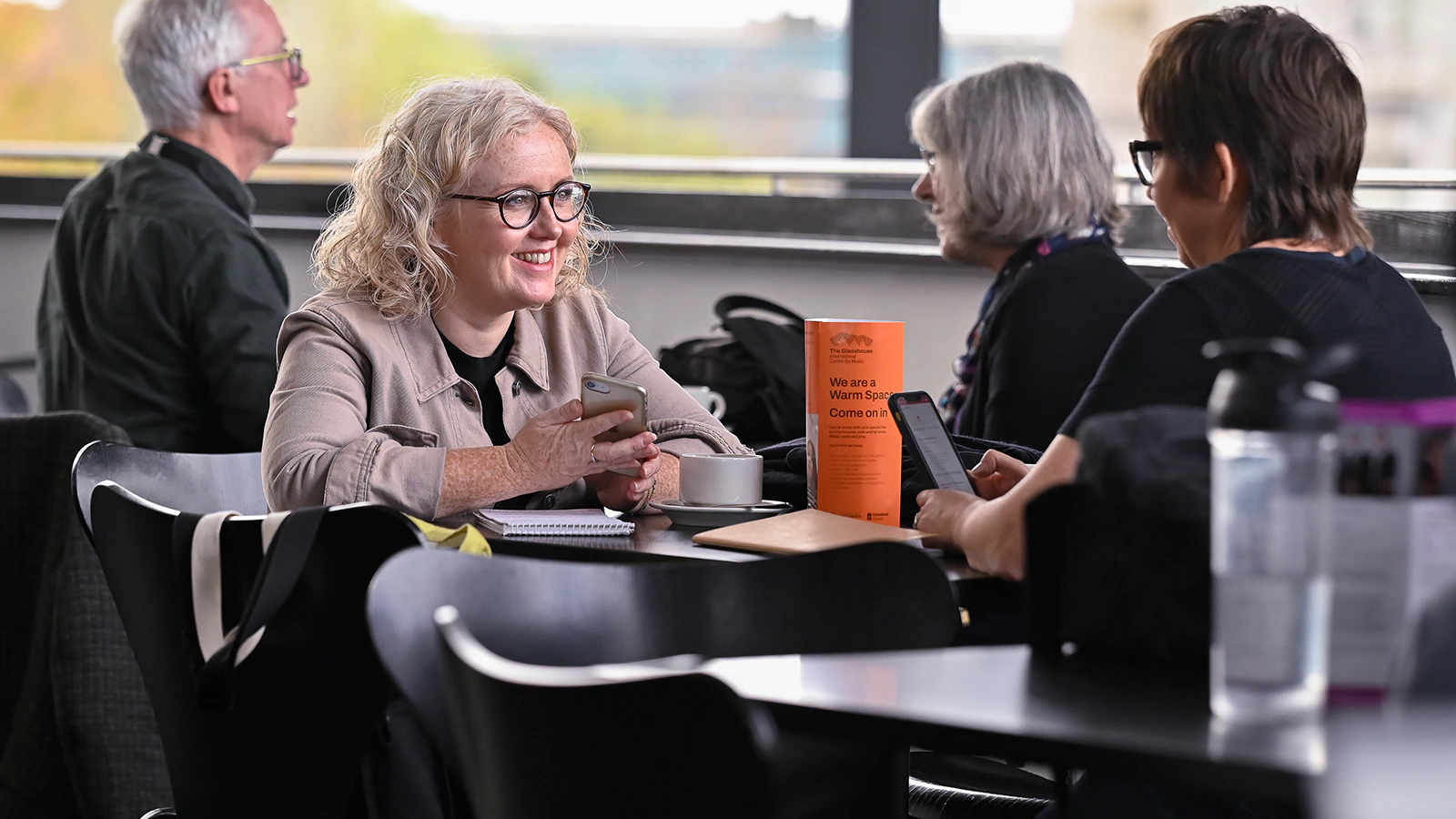 Two people sit together and talk at a table