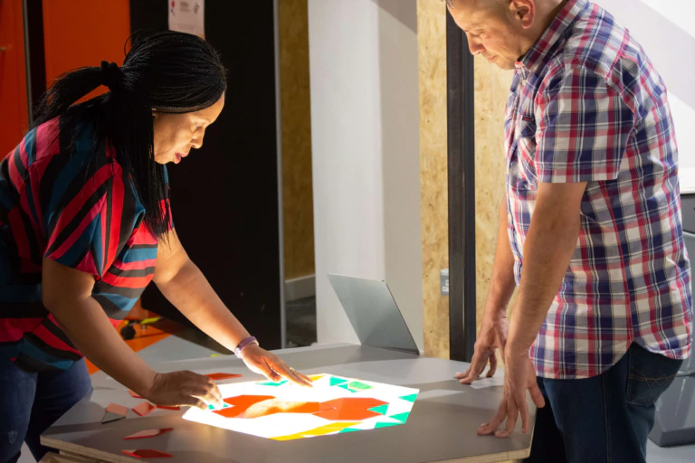 Two people use an interactive in a science centre