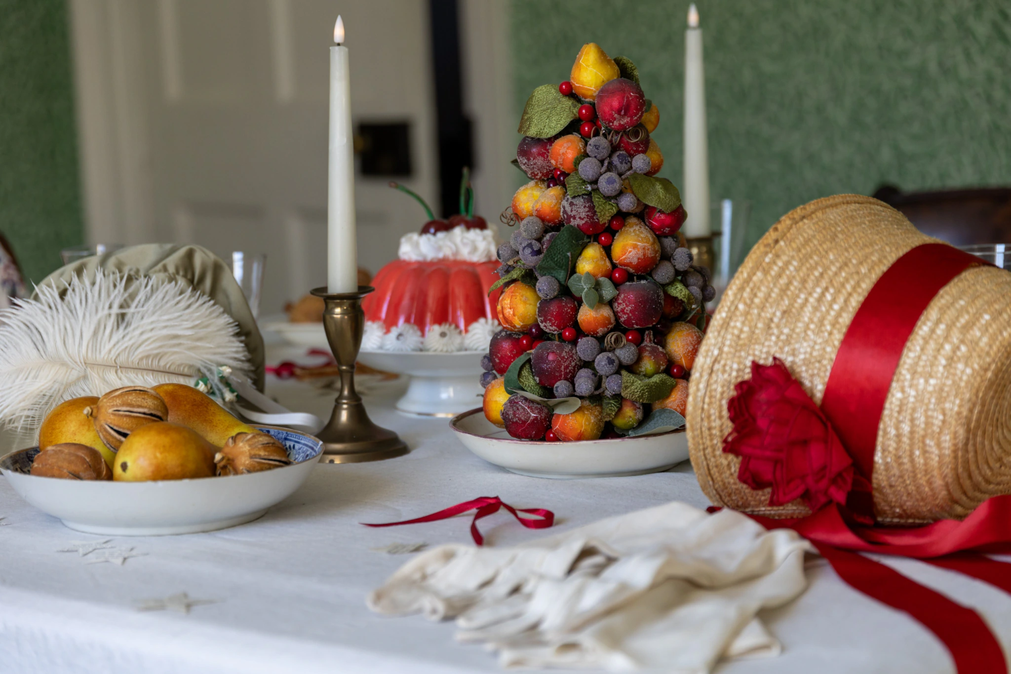 A straw hat and festive centrepiece are lain on a table