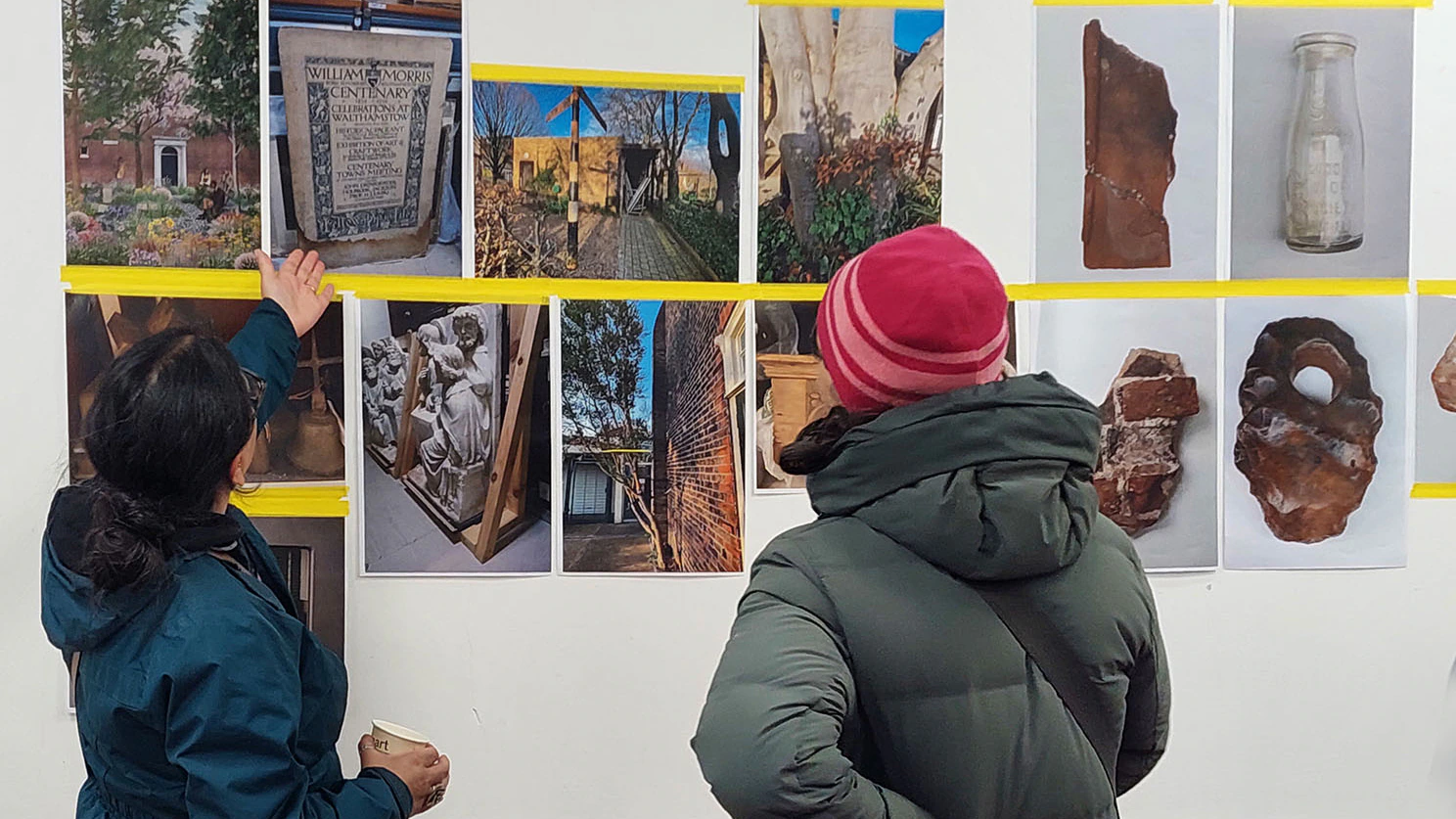 A person points to images on a wall at Vestry House Museum