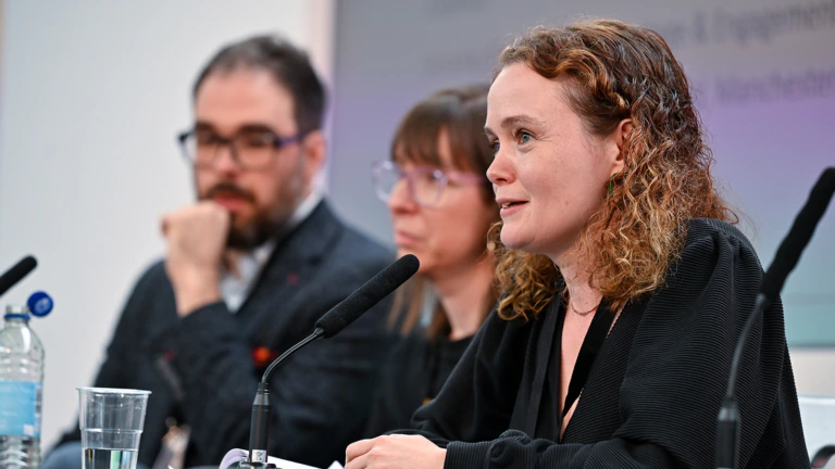 A person speaks on a panel at an MA conference