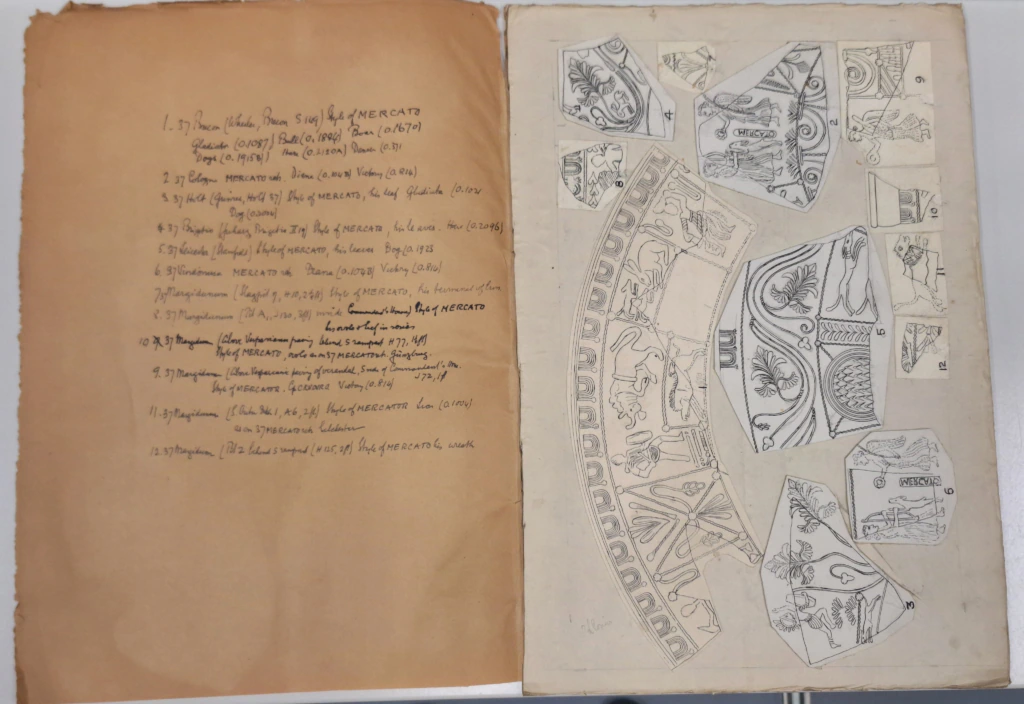 An open book shows handwritten notes on the left page and detailed black-and-white sketches of architectural fragments and decorative motifs on the right page. Both pages have a vintage, aged appearance.