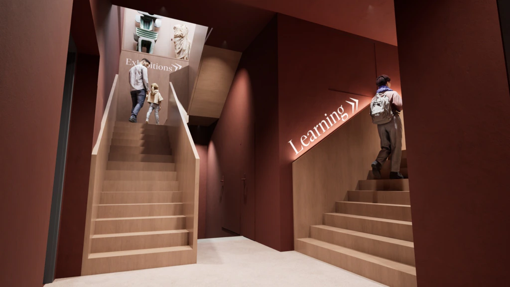 Two staircases in a modern indoor space: one leads to Exhibitions with statues above, where two people are ascending; the other leads to Learning, with one person walking up alone.