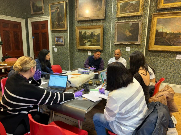 A group gathers for an activity around a table at Cyfarthfa Castle