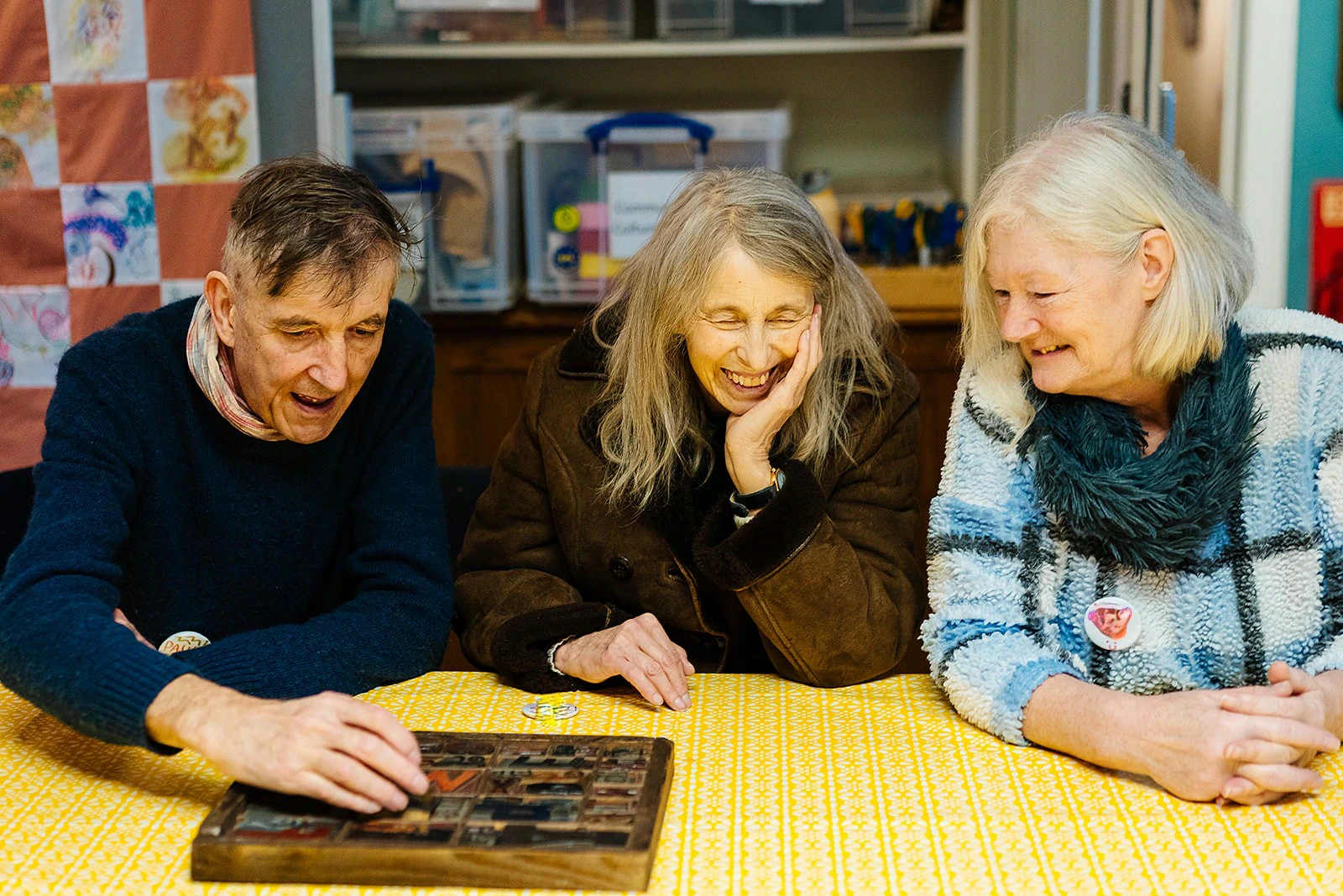 Three older people engaging in an activity at Norfolk Museums Service
